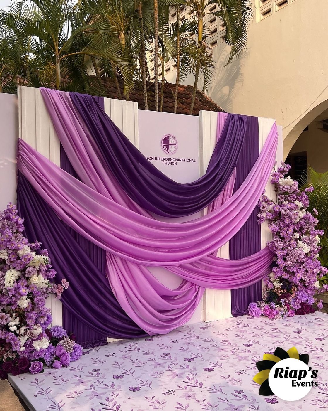 Fond de cérémonie drapé violet et fleurs
